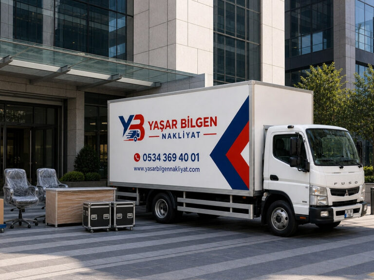 Modern ofis binası önünde park etmiş, Yaşar Bilgen Nakliyat yazılı beyaz kapalı kasa kamyon.